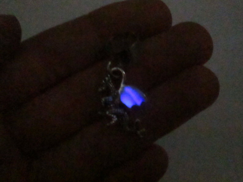 Tiny dragon ear cuff with purple glow in the dark wings