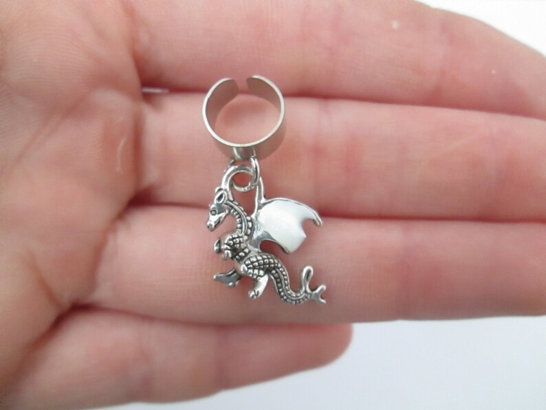 Tiny dragon ear cuff with purple glow in the dark wings