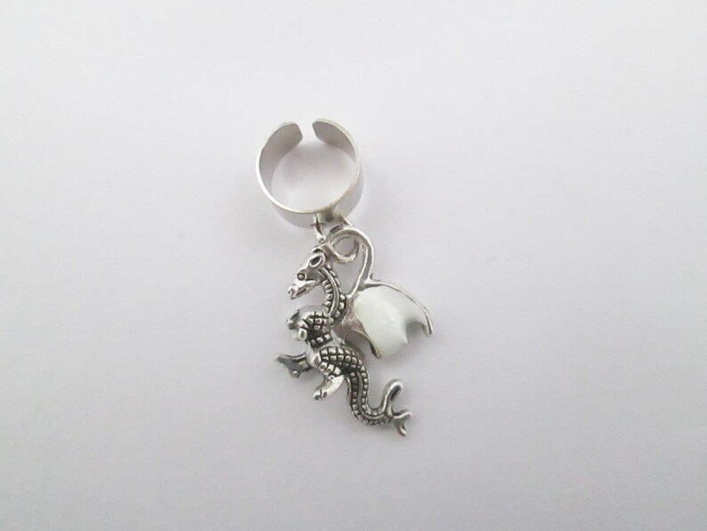 Tiny dragon ear cuff with purple glow in the dark wings