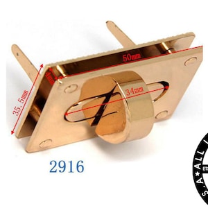 May include: Gold-toned metal clasp with a rectangular frame and a round, recessed opening. The clasp measures 50 mm by 35.5 mm. The text "2916" is printed below the clasp.