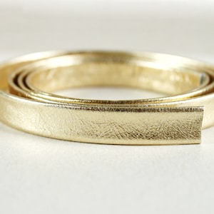 May include: Gold leather trim, rolled and ready to use for crafting projects. This trim is approximately 1 inch wide.