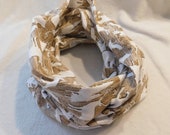 tan flannel infinity scarf featuring wood grain backing with white animal silhouettes, bear, moose, eagle, deer, hunting, mountain wild life
