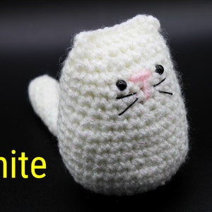 May include: White crocheted cat toy with black eyes and pink nose.
