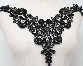 May include: Black lace trim with a delicate floral design. This trim is perfect for adding a touch of elegance to any garment.