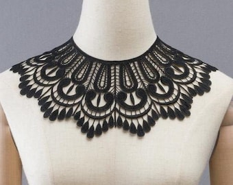 May include: Black lace collar with a scalloped edge and intricate floral design.
