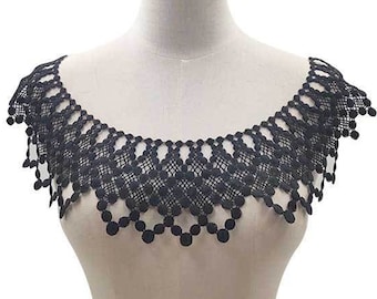 May include: A black lace collar featuring a repeating geometric pattern of interconnected circles and diamond shapes. The neckline has a scalloped edge with small circular accents hanging from the bottom, creating a decorative trim for clothing.