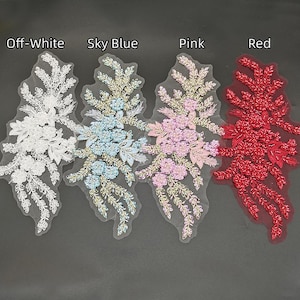 May include: Four floral lace appliques arranged side by side, labeled Off-White, Sky Blue, Pink, and Red. Each piece features intricate embroidery, beads, and sequins on a sheer mesh base, showcasing a detailed leaf and flower pattern design.