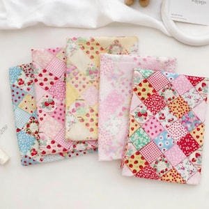 May include: A selection of fabric pieces with various patterns, including strawberries and flowers. The colour palette is predominantly pink, red, yellow, and blue. The patchwork design gives a vintage feel, suitable for sewing and craft projects.