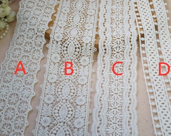 May include: Four different white lace trims with varying patterns. The trims are labeled A, B, C, and D.