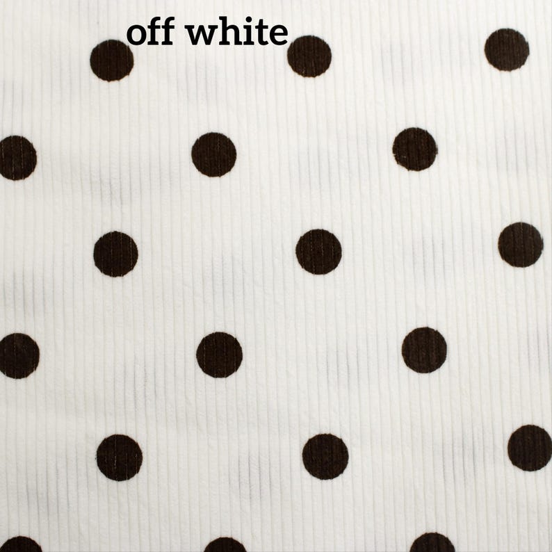May include: An off-white fabric featuring a repeating pattern of dark brown polka dots. The material has a visible vertical ribbed texture throughout the surface. The text "off white" is printed in black in the upper left corner of the image.