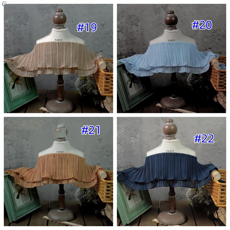 May include: Four fabric neck ruffs in different colors: tan (#19), light blue (#20), orange (#21), and navy blue (#22). Each is pleated and displayed on a mannequin bust with "PARIS" printed on it.