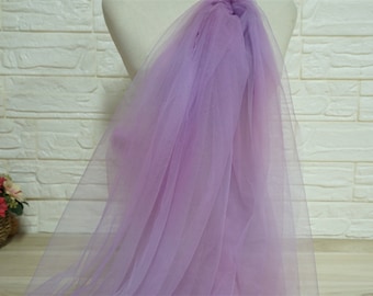 May include: A sheer lilac tulle fabric with a gradient effect, transitioning from a lighter shade to a darker shade of purple.