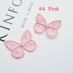 May include: Two pink lace butterfly appliques. The butterflies are delicate and intricate, with a fine mesh design. #4 Pink