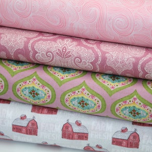 May include: Stack of four fabric swatches with different patterns. The top swatch is pink with a swirling pattern. The second swatch is pink with a paisley pattern. The third swatch is pink with a green and blue floral pattern. The bottom swatch is white with a red barn pattern.