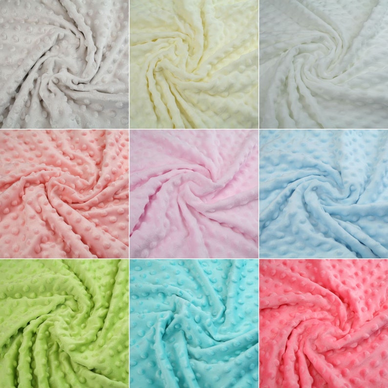 May include: A collection of nine fabric swatches in various colours, including white, yellow, pink, light blue, green, turquoise, and coral. Each swatch features a textured, raised dot pattern.