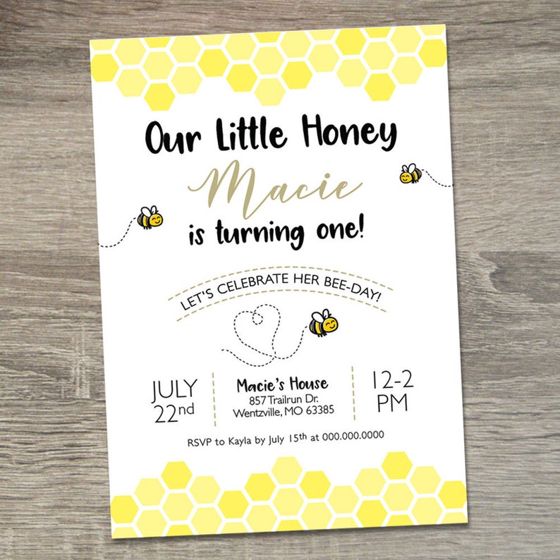 May include: A yellow and white honeycomb pattern background with a white invitation for a first birthday party. The invitation says "Our Little Honey Macie is turning one! Let's celebrate her bee-day!" with a bee illustration. The invitation includes the date, time, and location of the party. RSVP information is also included.
