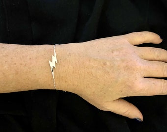 Bracelet with a pendant in the shape of a lightning bolt