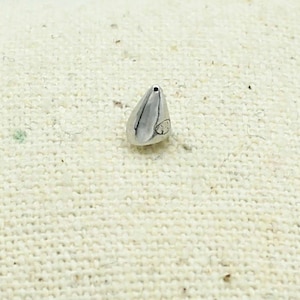 Ear chip in the shape of a silver nail. Sold individually