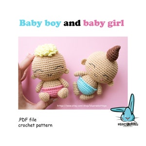 May include: Crochet pattern PDF for making two amigurumi baby dolls. One doll is a boy with blonde hair and a pink diaper. The other doll is a girl with brown hair and a blue diaper. The dolls have smiling faces with closed eyes. The pattern is available on Etsy.