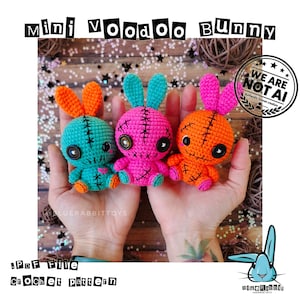 May include: Three small crochet voodoo bunny dolls in teal, pink, and orange. Each doll features button eyes, stitched mouth details, and long ears. The text reads MINI VOODOO BUNNY and PDF FILE CROCHET PATTERN. A circular WE ARE NOT AI stamp is visible.