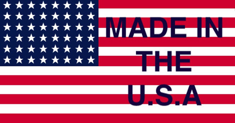 May include: An American flag with 13 red and white stripes and 50 white stars on a blue field. The text "MADE IN THE U.S.A." is printed in black letters on the flag.