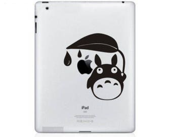 May include: Black and white sticker featuring a cartoon character with large eyes and a round body, under a leaf with raindrops. The sticker is applied to a white iPad.