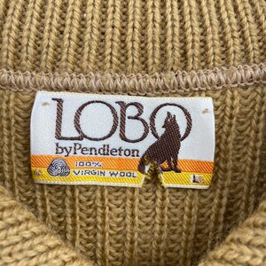 May include: A brown knit sweater with a label that reads "LOBO by Pendleton 100% VIRGIN WOOL".