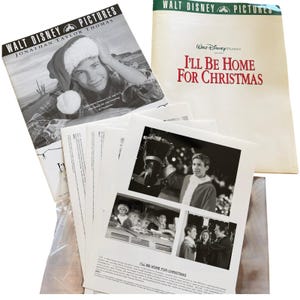 May include: A collection of promotional press kit materials for the Walt Disney Pictures film I'll Be Home For Christmas, featuring a black and white portrait of Jonathan Taylor Thomas in a Santa hat and several stills from the movie scenes.