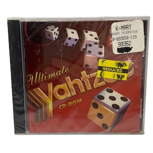 May include: Sealed CD-ROM of the game "Ultimate Yahtzee." The cover features dice illustrations and the game's title in gold lettering on a red background. A K-Mart sticker indicates a reduced price.