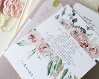 May include: A white card with a floral design featuring pink roses and green leaves. The card has a bible verse from Psalms 103:1-5 NKJV printed on it.