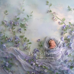 May include: A newborn baby wrapped in a soft, lavender-colored blanket, nestled in a floral arrangement. The background features a pastel sky and delicate purple flowers. The image includes the text "May & Moss Newborn digitals by Lori lesh photography."