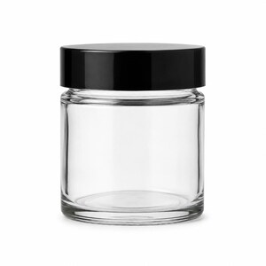May include: A clear glass jar with a smooth, cylindrical body and a flat, solid black screw-top lid. The container features a wide mouth and a thick, sturdy base, providing a transparent view into the interior space of the empty storage vessel.