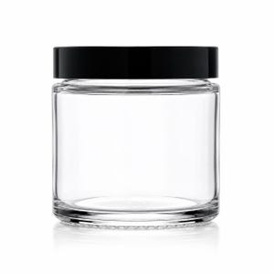 May include: A clear, cylindrical glass jar with a smooth, transparent body and a flat, solid black screw-top lid. The container features a wide mouth and a thick, sturdy base, providing a simple and functional design for storage or display purposes.