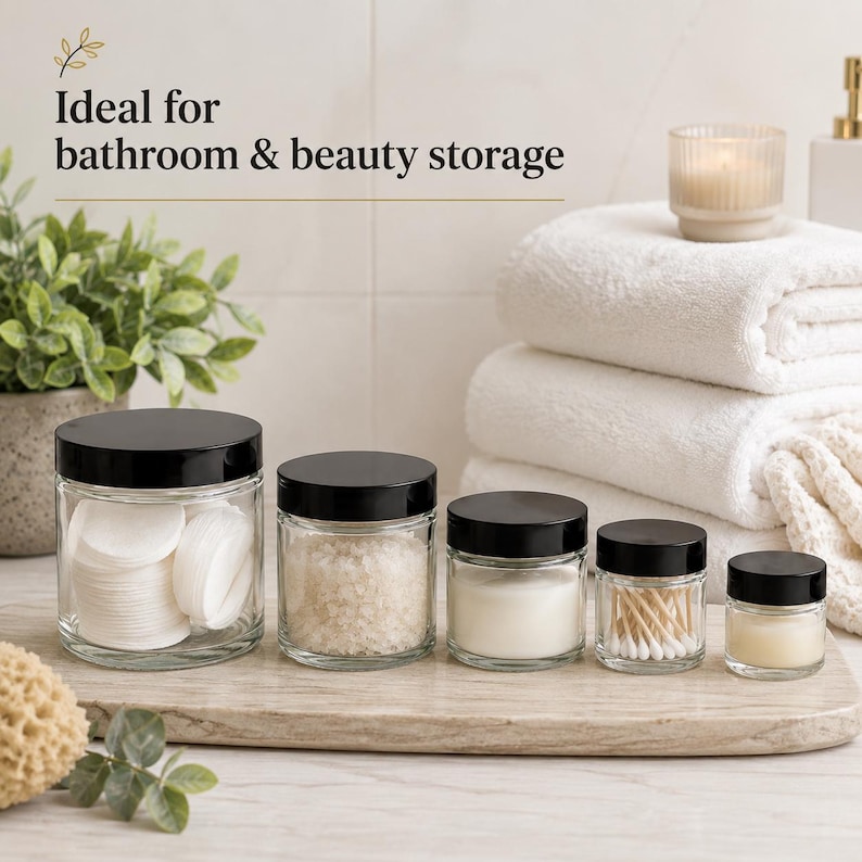 Five sizes of clear glass cosmetic jars with black screw lids, available in 15ml, 30ml, 60ml, 120ml and 250ml capacities.