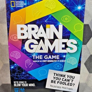May include: A boxed board game titled "Brain Games" with the National Geographic Channel logo. The box features a colorful design with the game's title in large white letters. Includes the text "We're going to blow your mind" and "Think you can't be fooled?"