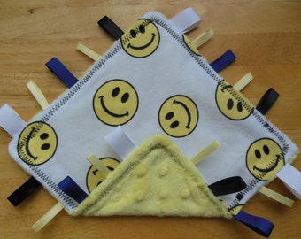 White and yellow Smiley Face crinkle sensory tag blanket