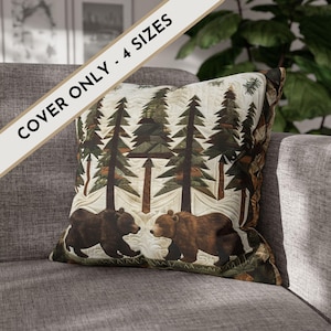 May include: Square pillow cover featuring a forest scene with two brown bears and tall pine trees. The pillow has a quilted design with a cream-colored background. Text on the image reads "COVER ONLY - 4 SIZES".