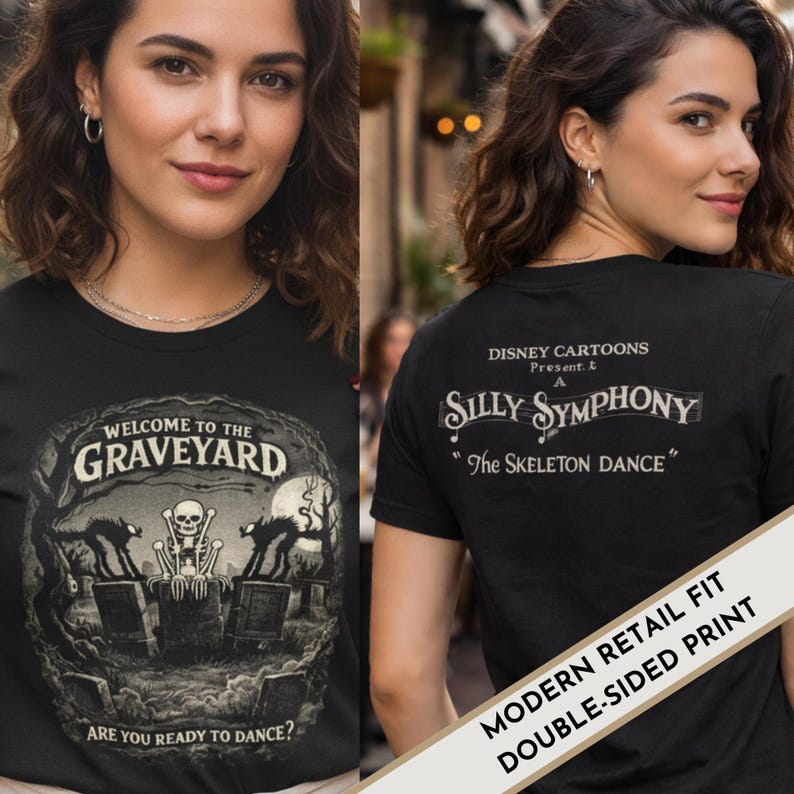 May include: Black double-sided t-shirt featuring a graveyard scene with a skeleton and the text "WELCOME TO THE GRAVEYARD". The back of the shirt displays "Silly Symphony" and "The Skeleton Dance" text. The shirt has a modern retail fit.