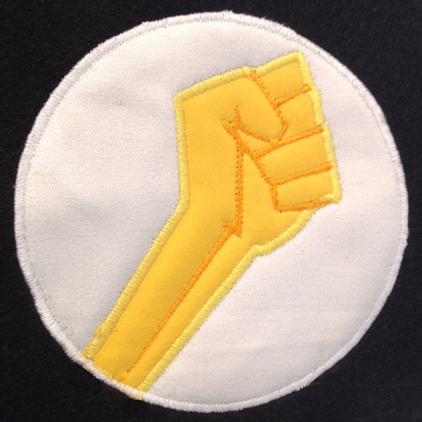 Fight the power! Powerful fist pump applique design - a sign of rebellion, power and protest.  Clenched fist as a revolutionary symbol