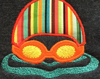 Swimmer with swim cap and goggles machine embroidery and appliqué designs in several sizes and styles.  Perfect for swim team gear.