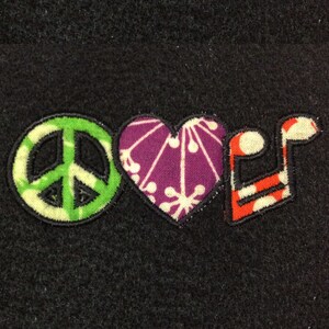 Peace, love and music machine applique design. Two different versions in three sizes.