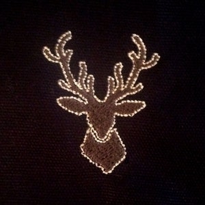 Deer head machine applique and filled embroidery design in several sizes.