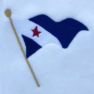 May include: A blue and white flag with a red star on a gold pole. The flag is waving in the wind.