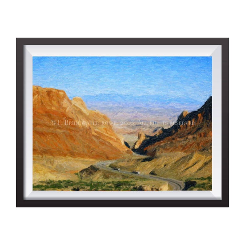 May include: A framed landscape painting depicting a winding road through a desert canyon with orange rock formations, dark shadows, and a bright blue sky. The text &copy; T. BRIDGEWATER-ROWE, 2016, ALL RIGHTS RESERVED is printed across the center.