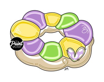 May include: A purple, green, and yellow donut with a heart-shaped design. The donut is decorated with a white glaze and has a small heart on the side. The text "The Paint Splash" is on the left side of the donut.