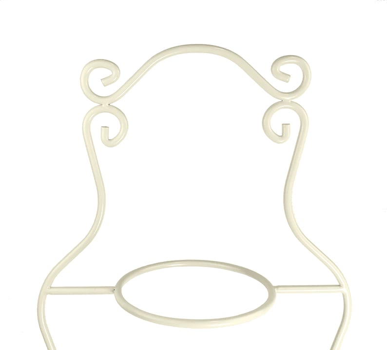 May include: White metal cake stand with a round base and ornate scrollwork details.