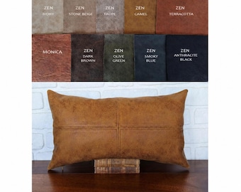 May include: A rectangular camel-colored faux leather pillow with a central cross-stitch seam. Above the pillow, a color palette displays ten fabric swatches labeled Zen Ivory, Stone Beige, Taupe, Camel, Terracotta, Monica, Dark Brown, Olive Green, Smoky Blue, and Anthracite Black.