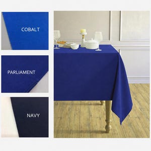 May include: A rectangular tablecloth in a solid deep blue color draped over a table. Three smaller inset panels display fabric swatches labeled with the text COBALT, PARLIAMENT, and NAVY, showing variations of blue fabric textures and shades.