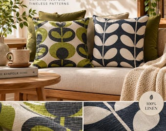 May include: Two square linen throw pillows featuring botanical patterns. One pillow displays an olive green and dark gray circular leaf design labeled Linden, while the other shows a navy blue and cream vertical leaf pattern labeled Nora.