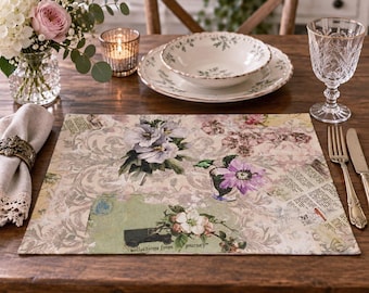 May include: A rectangular placemat featuring a collage design with vintage floral illustrations, script text, and a small black car graphic. The background has a light beige damask pattern with layered paper elements in muted green, pink, and cream tones.